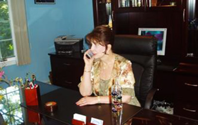 Carol Denicker sitting at desk